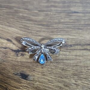 vintage Avon bow brooch with faux marcasite and a blue glass or rhinestone